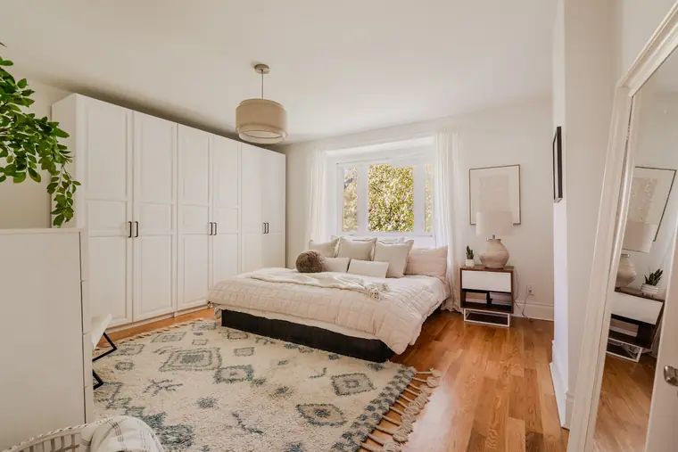 Primary bedroom with built-in wardrobes and a large window